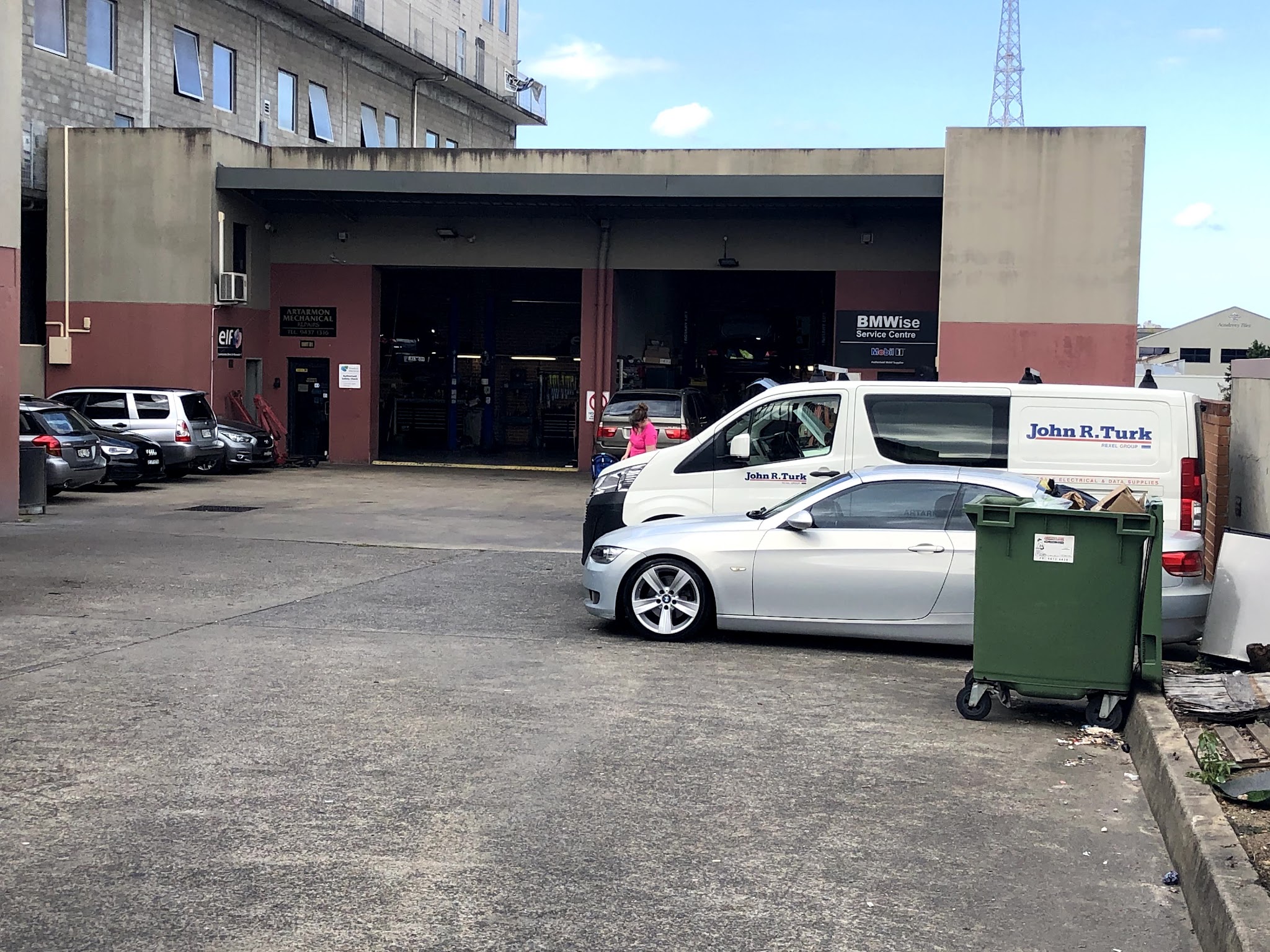Open workshop bays at Artarmon Mechanical Repairs with hoists and cars in for work